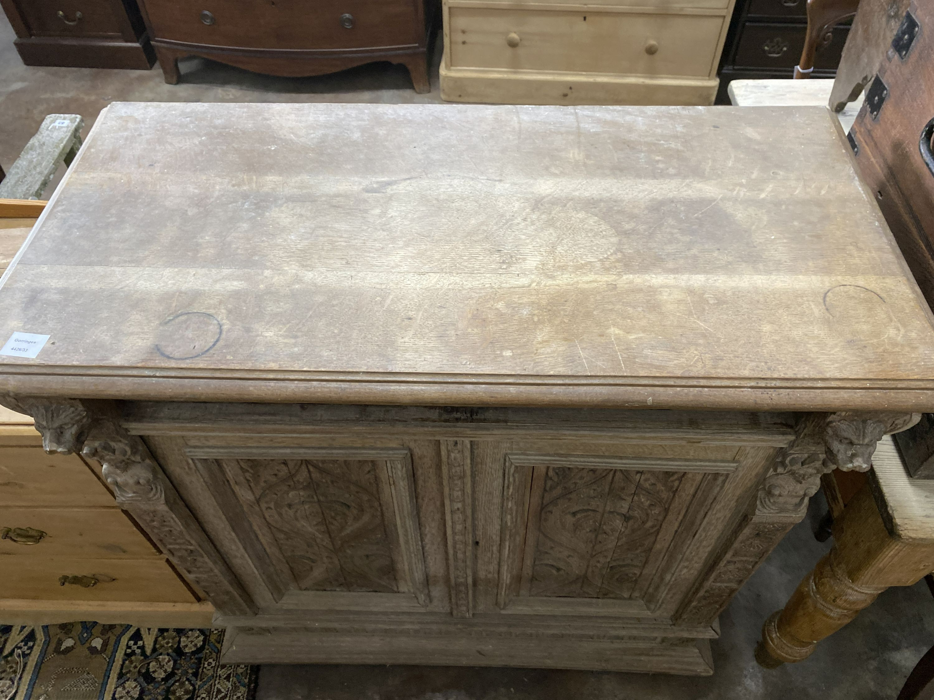 A late 19th century Flemish carved bleached oak two door side cabinet, width 106cm, depth 50cm, height 104cm